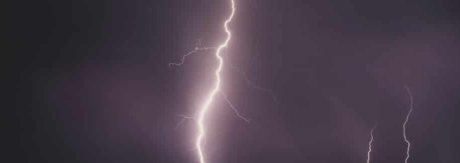 lightning strike during nighttime over body of water