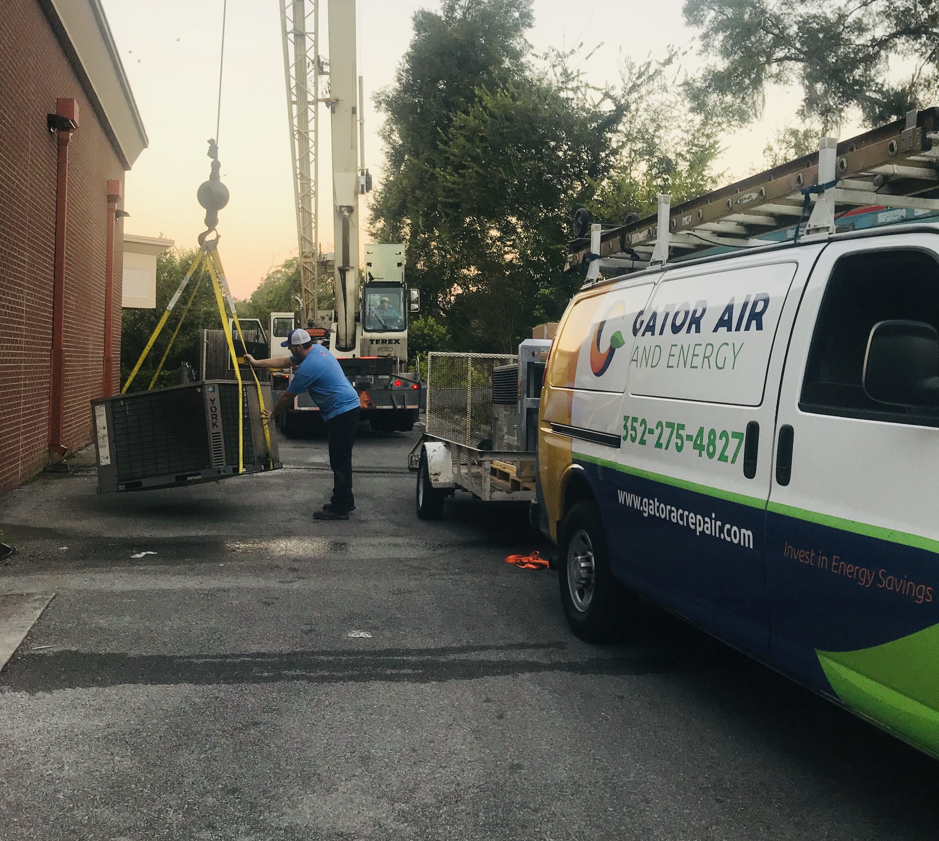 Commercial air conditioners - a crane delivering an unit to the top of a building.commercial HVAC installation repair maintenance Gator Air & Energy Gainesville FL